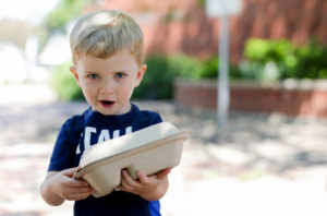 Little boy holds food tray at the Lunch Lab.
